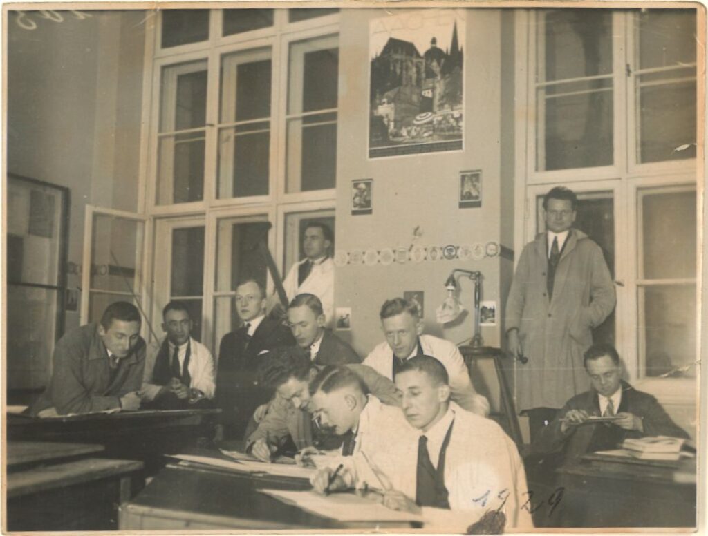 Studenten im Jahre 1929, in einem Saal an Tischen. Vielleicht ein Seminar.